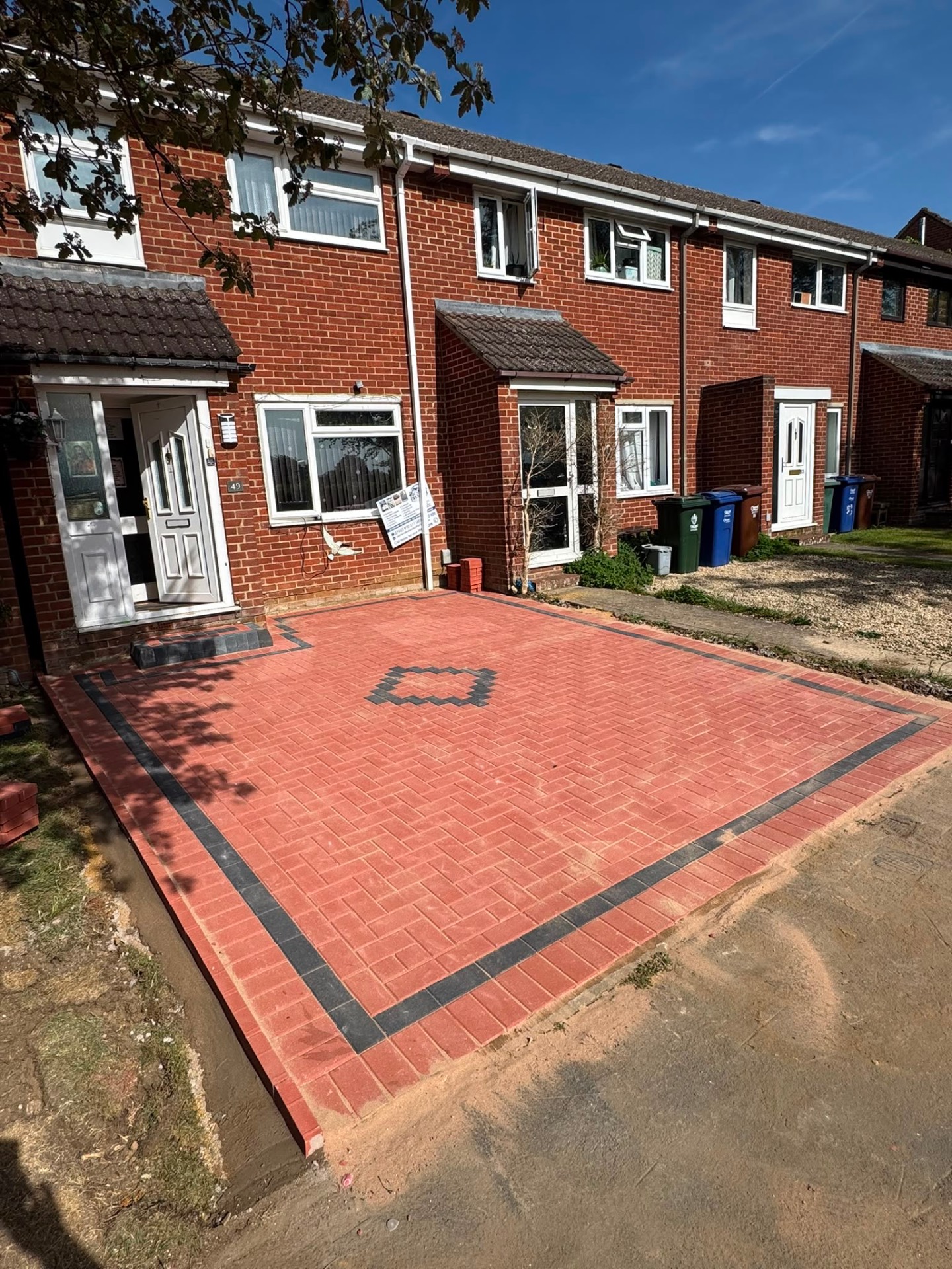 Red herringbone block paved driveway with charcoal border and diamond feature in Gloucester