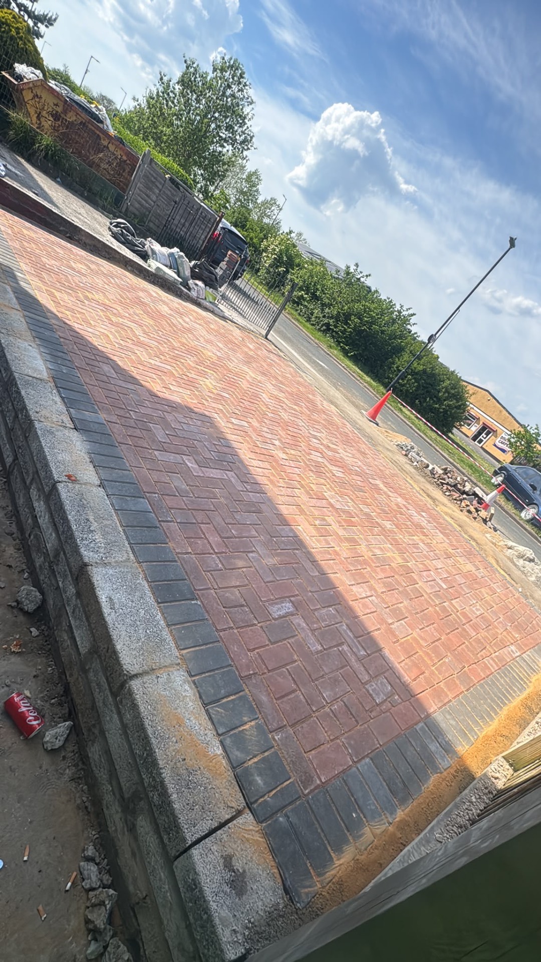 Red brindle block paved driveway with charcoal border built over a new retaining wall in Gloucester