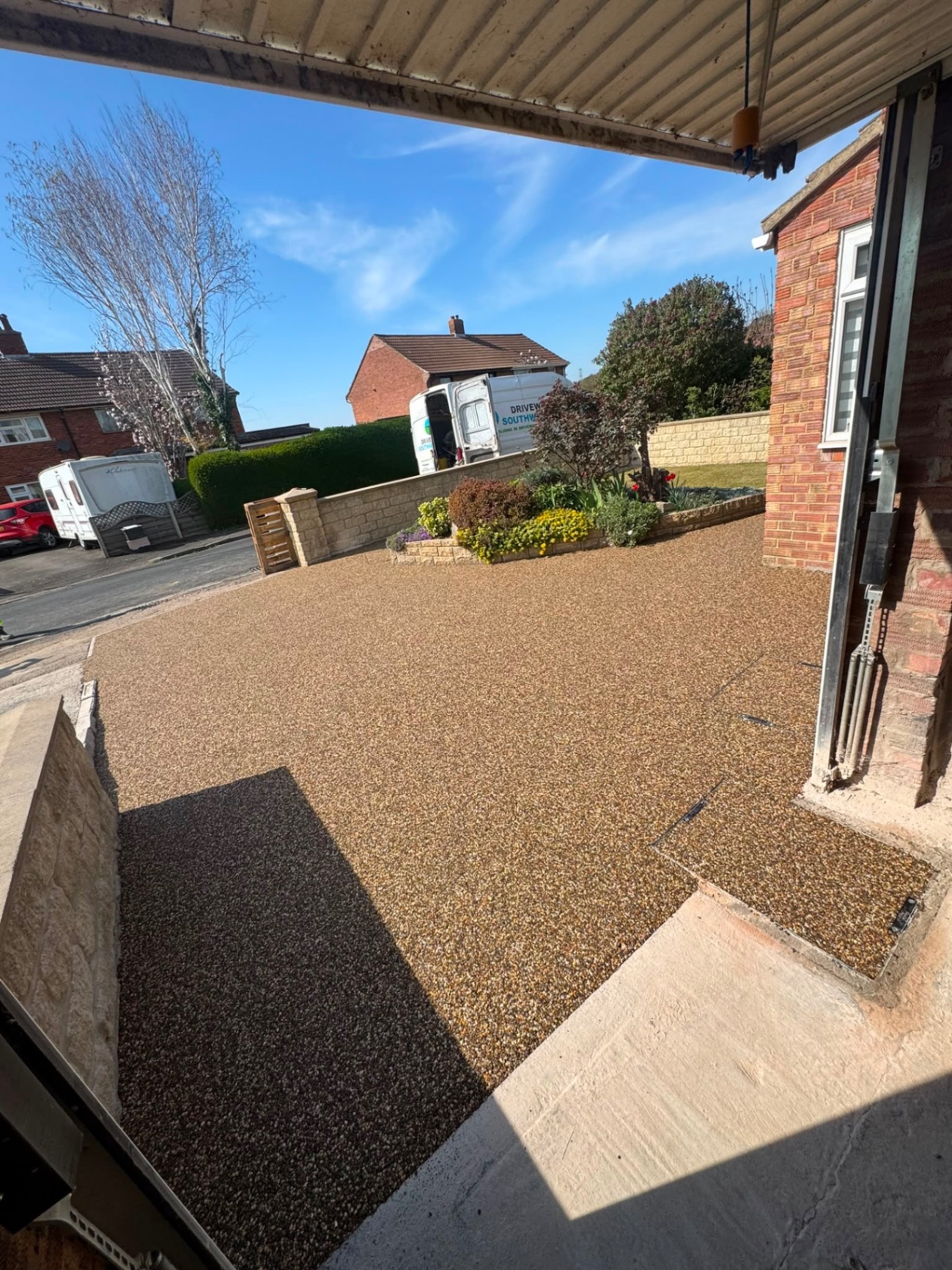 Gold resin bound front driveway seen from inside a garage, running out to the road in Gloucester