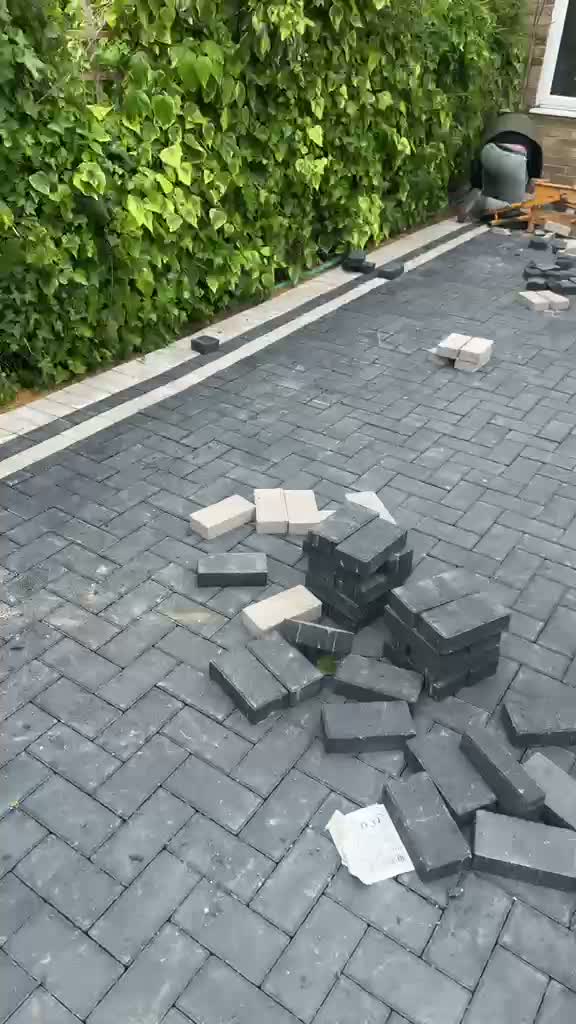 Video of a paving crew cutting blocks in against an edge course on a Gloucester driveway