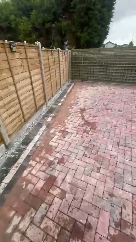 Walkthrough of a red brindle block paved rear garden in Gloucester with charcoal border and fencing