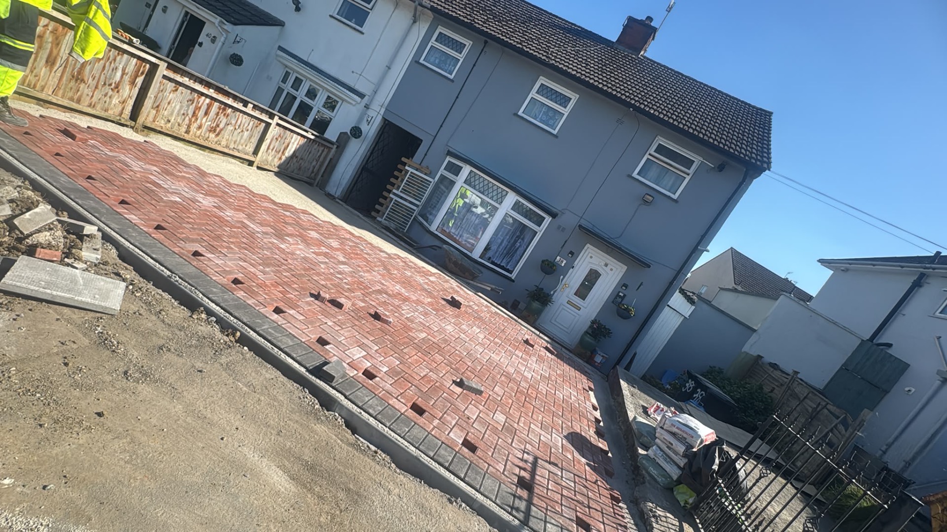 Red block paved front driveway part-laid with charcoal border in Gloucester